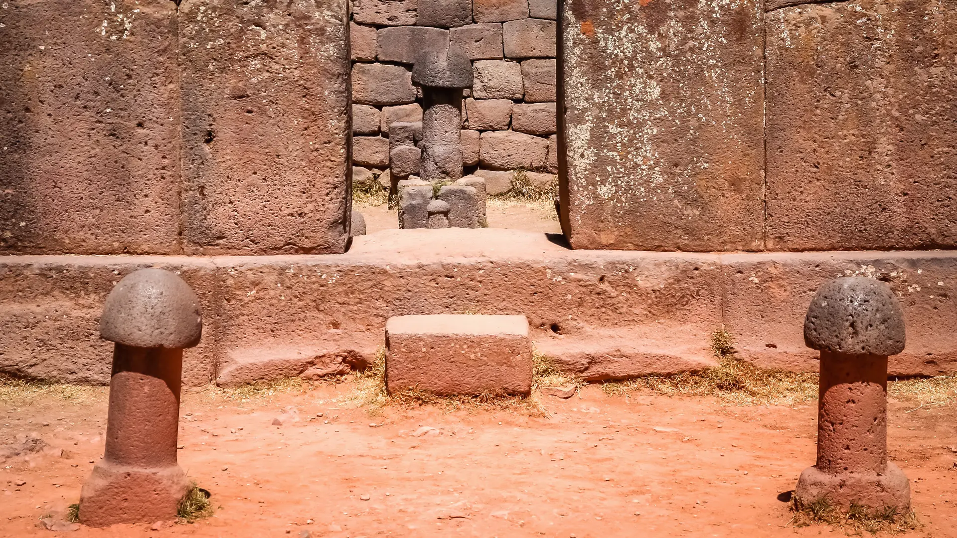 Carved stone walls and ceremonial monuments inside the ancient Inca temple of Chucuito bathed in natural light.